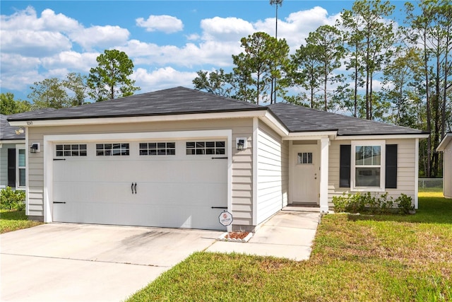 ranch-style home with a front lawn and a garage