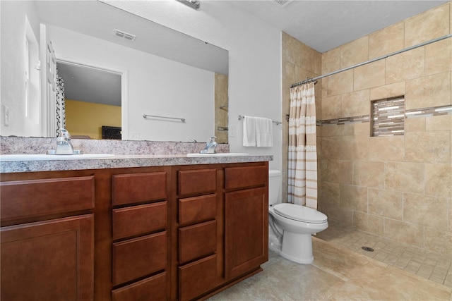 bathroom featuring vanity, toilet, curtained shower, and tile patterned flooring