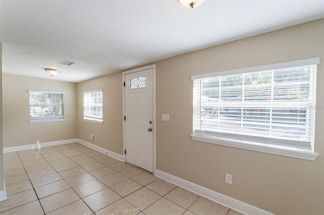 foyer entrance with light tile patterned floors