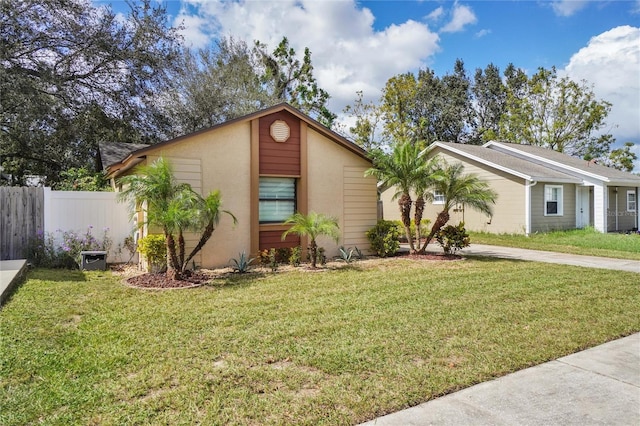 ranch-style home featuring a front yard