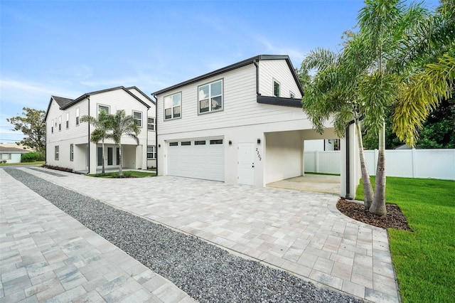 view of front of house featuring a balcony, a garage, and a front lawn