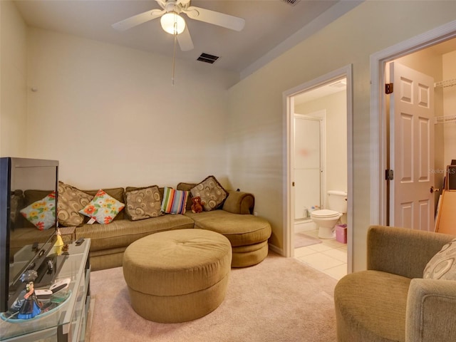 carpeted living room with visible vents, ceiling fan, and tile patterned floors