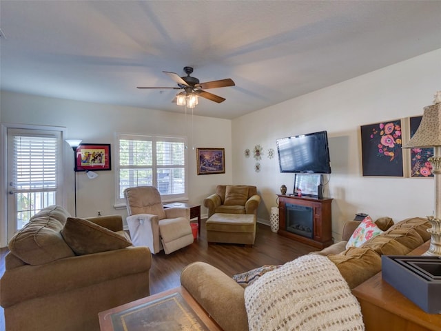 living room featuring ceiling fan and dark wood finished floors