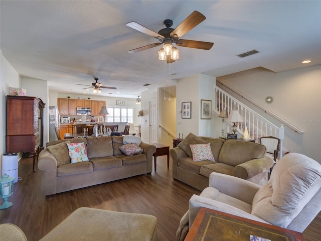 living room with stairs, wood finished floors, visible vents, and recessed lighting