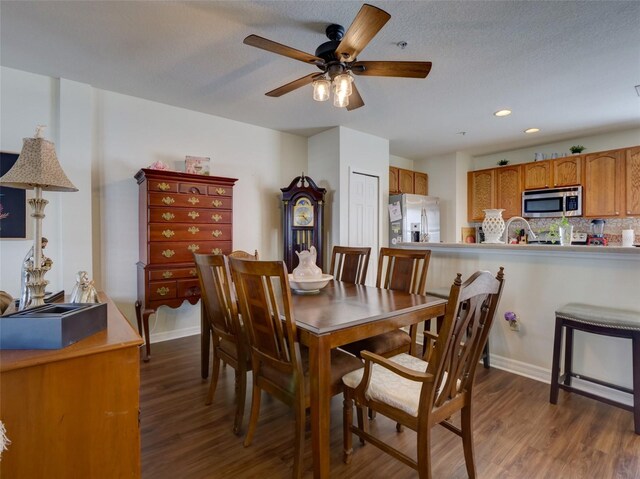 dining area featuring dark wood-type flooring, recessed lighting, ceiling fan, and baseboards