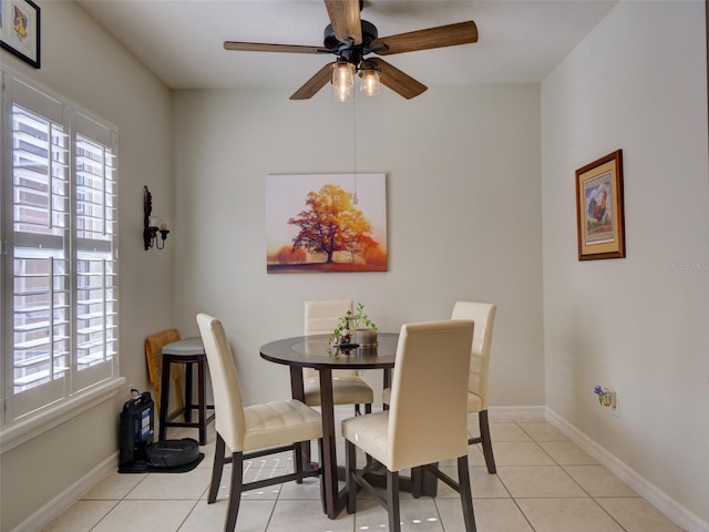 dining room with light tile patterned floors, ceiling fan, and baseboards