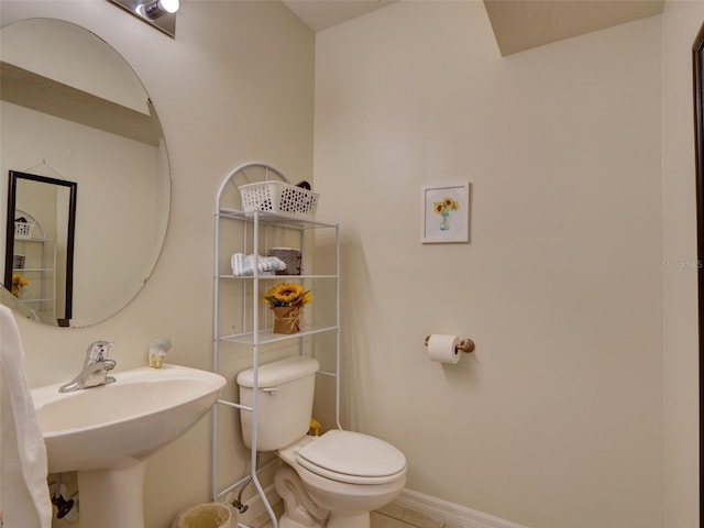535 Crimson Ln, Winter Springs, FL 32708 - half bathroom featuring toilet, a sink, baseboards, and tile patterned flooring