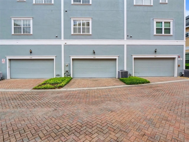 535 Crimson Ln, Winter Springs, FL 32708 - rear view of house with stucco siding, driveway, and an attached garage