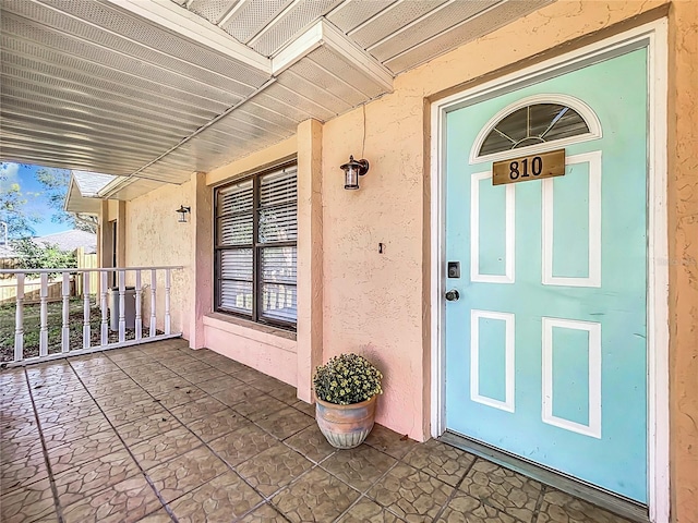 doorway to property featuring a porch