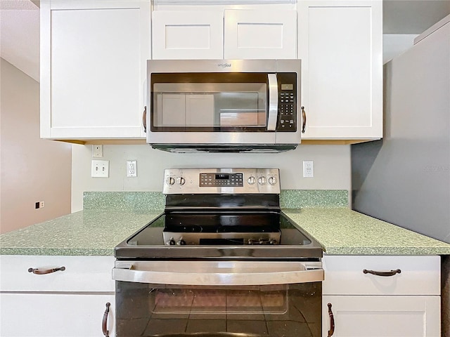 kitchen with white cabinetry and appliances with stainless steel finishes