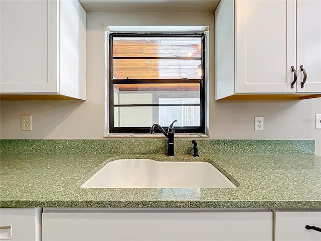 interior details with sink and white cabinets