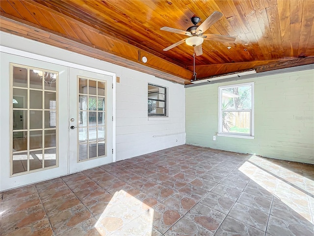 unfurnished sunroom featuring french doors, wooden ceiling, lofted ceiling, and ceiling fan