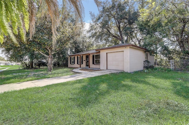 ranch-style home with a front lawn and a garage