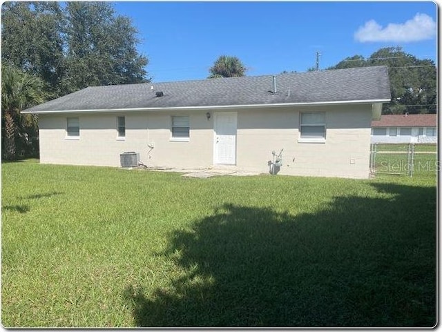 back of property featuring a lawn