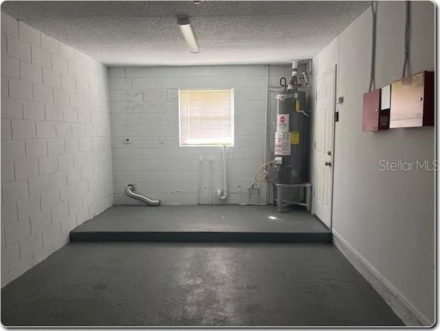 basement featuring a textured ceiling and gas water heater