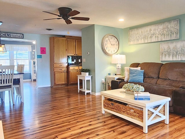 living room with ceiling fan and wood-type flooring