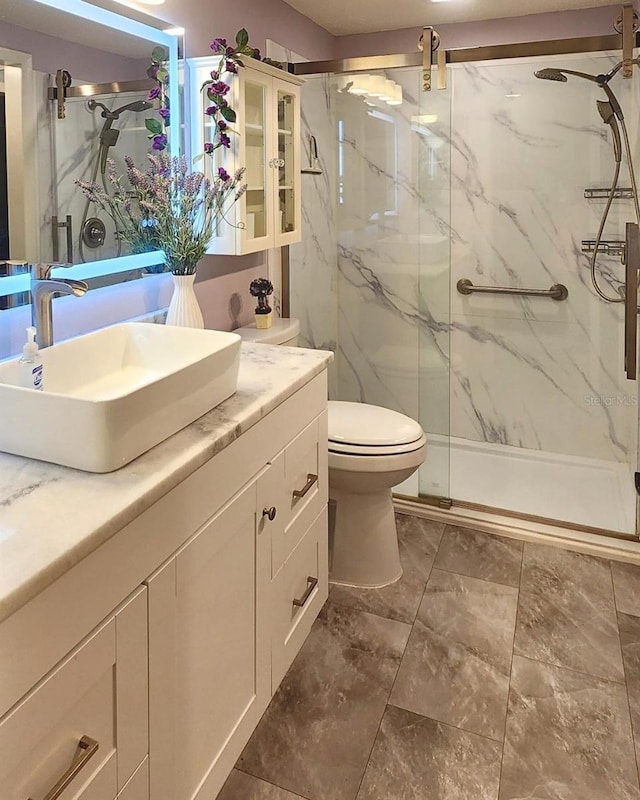 bathroom with vanity, toilet, and walk in shower