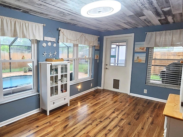 entryway featuring dark hardwood / wood-style flooring and wood ceiling