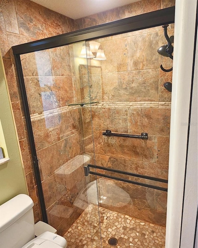 bathroom with an enclosed shower and toilet