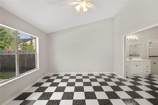 interior space with lofted ceiling, sink, and ceiling fan