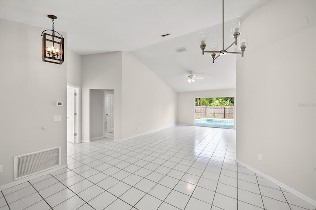 tiled spare room featuring high vaulted ceiling and ceiling fan with notable chandelier