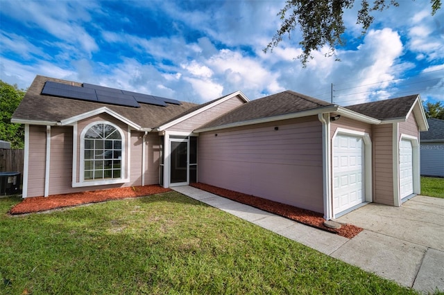 ranch-style house with solar panels and a front lawn