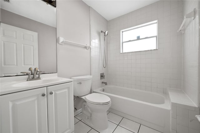 bathroom with tile patterned flooring, toilet, vanity, and shower / washtub combination