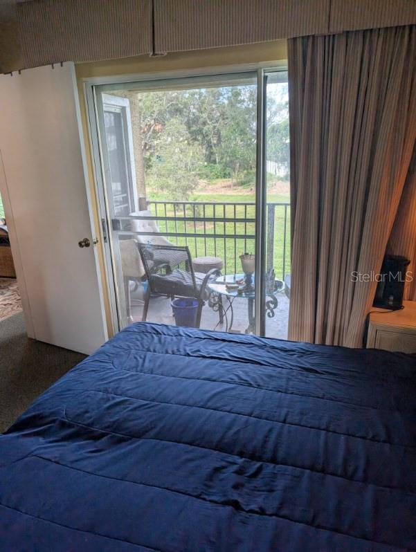 bedroom featuring carpet flooring and access to outside