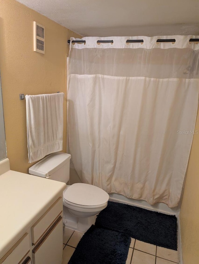 bathroom with vanity, a shower with shower curtain, toilet, and tile patterned floors