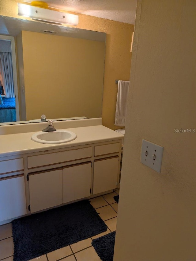 bathroom with vanity and tile patterned flooring