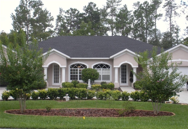 ranch-style home featuring a front yard and a garage