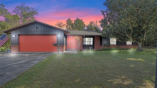 ranch-style home featuring a yard and a garage