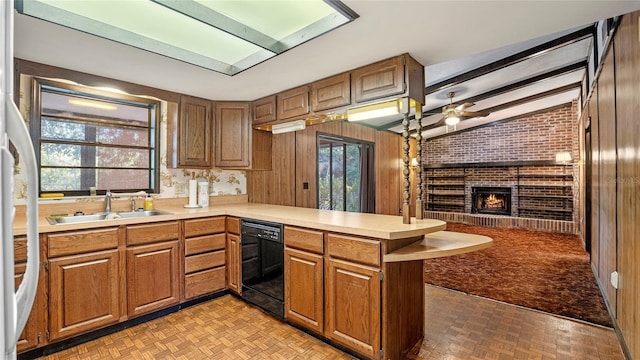 kitchen with kitchen peninsula, dishwasher, lofted ceiling with beams, and plenty of natural light