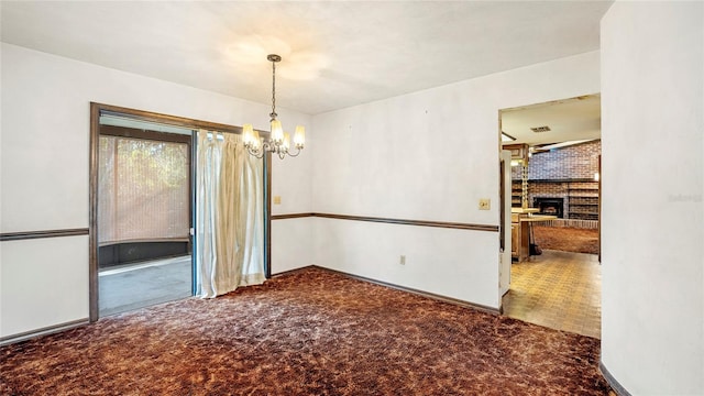 unfurnished dining area with carpet, a chandelier, and a fireplace