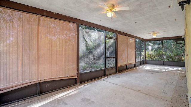 unfurnished sunroom featuring ceiling fan