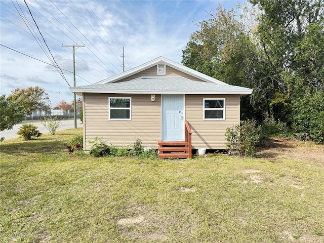 bungalow-style home featuring a front lawn