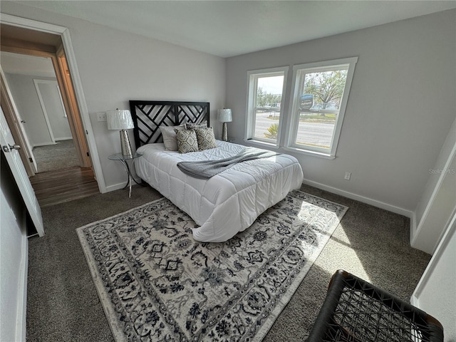 bedroom featuring dark colored carpet