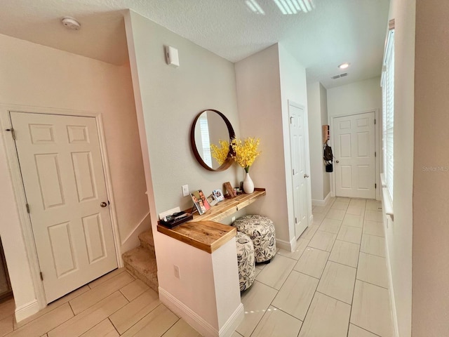 hallway with a textured ceiling