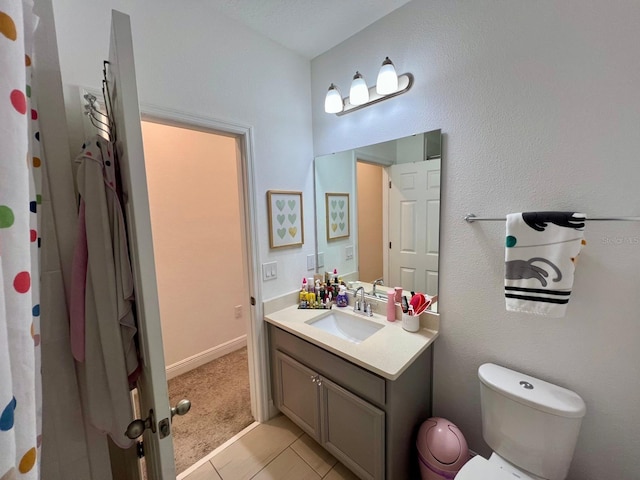 bathroom featuring vanity, toilet, and tile patterned floors