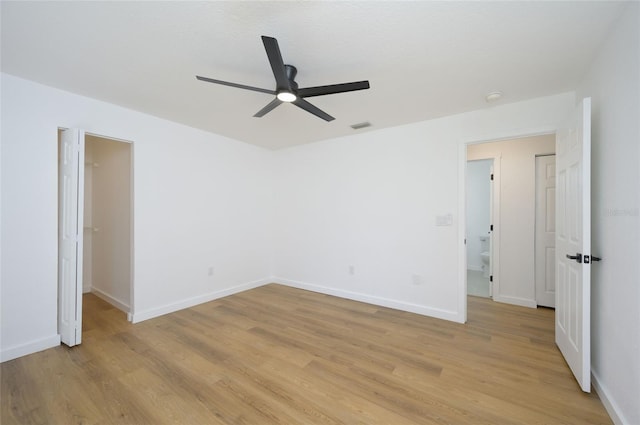 empty room with light hardwood / wood-style floors and ceiling fan