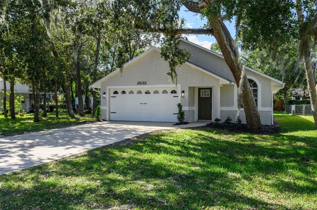 single story home featuring a front yard and a garage