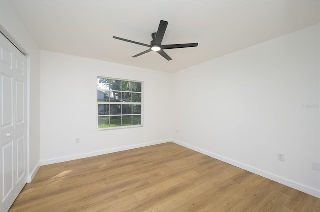 empty room featuring light wood-type flooring and ceiling fan