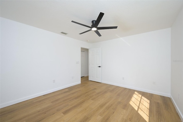 empty room featuring ceiling fan and light wood-type flooring