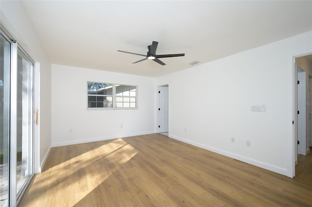 spare room with hardwood / wood-style floors and ceiling fan