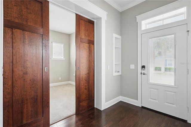 entryway with baseboards, dark wood finished floors, and crown molding