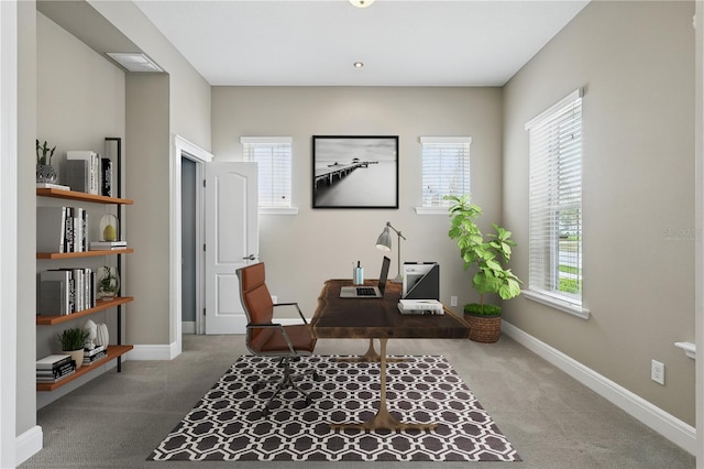 carpeted home office with baseboards