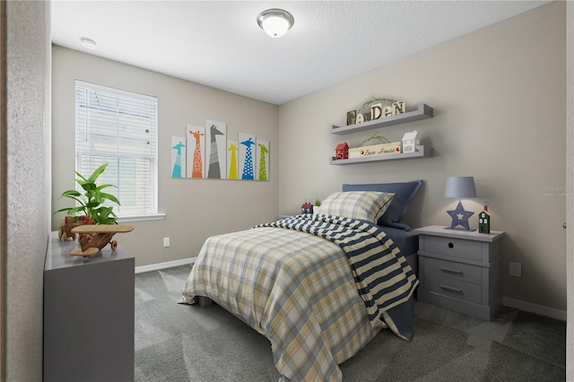 bedroom featuring dark colored carpet and baseboards