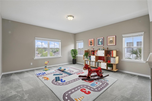 recreation room with carpet flooring and baseboards