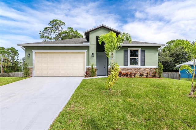 view of front of property featuring a front yard and a garage