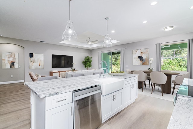 kitchen with stainless steel dishwasher, ceiling fan, sink, decorative light fixtures, and white cabinets